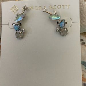 Kendra Scott silver climber earrings.
